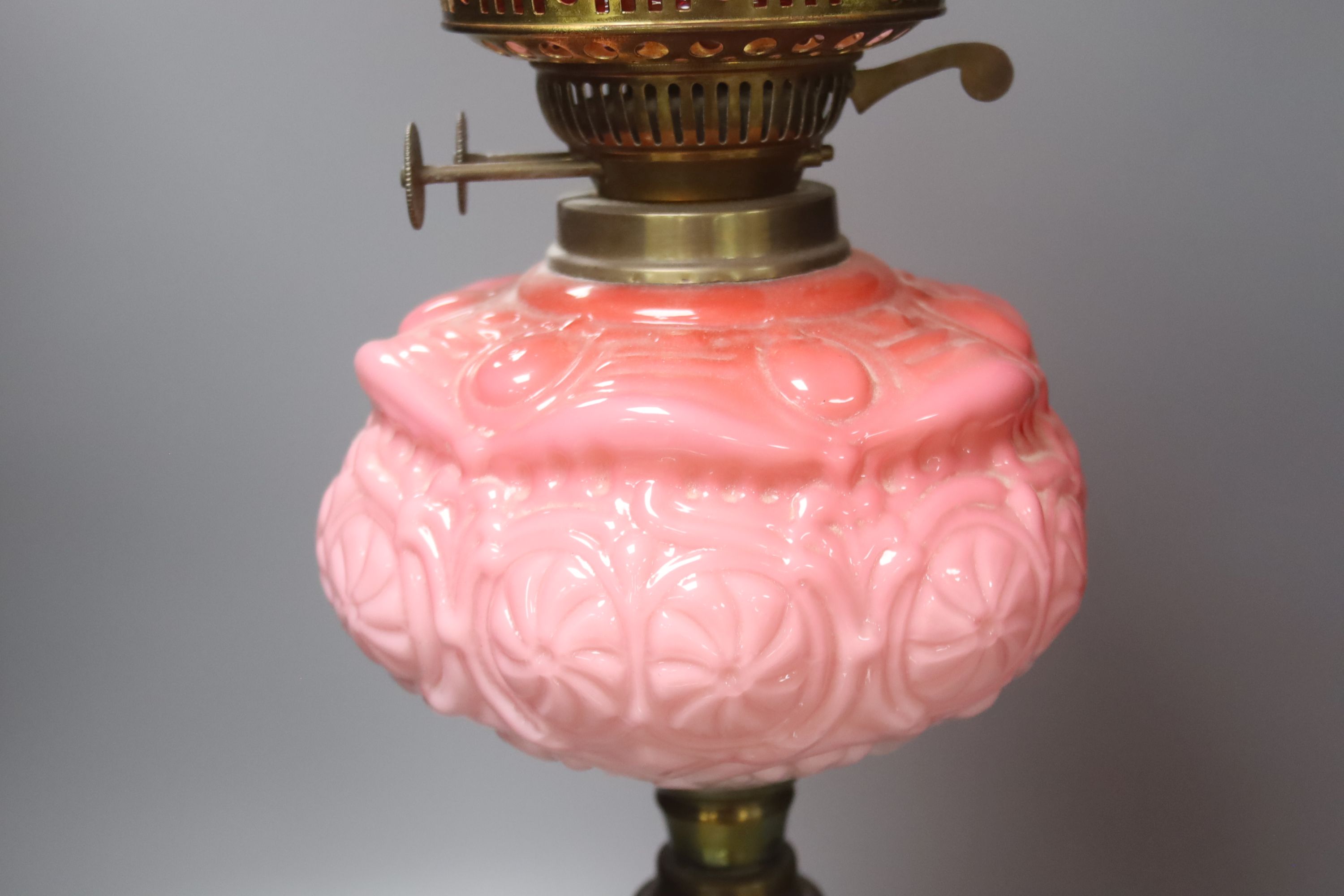 A Victorian brass and pink glass oil lamp, height 70cm